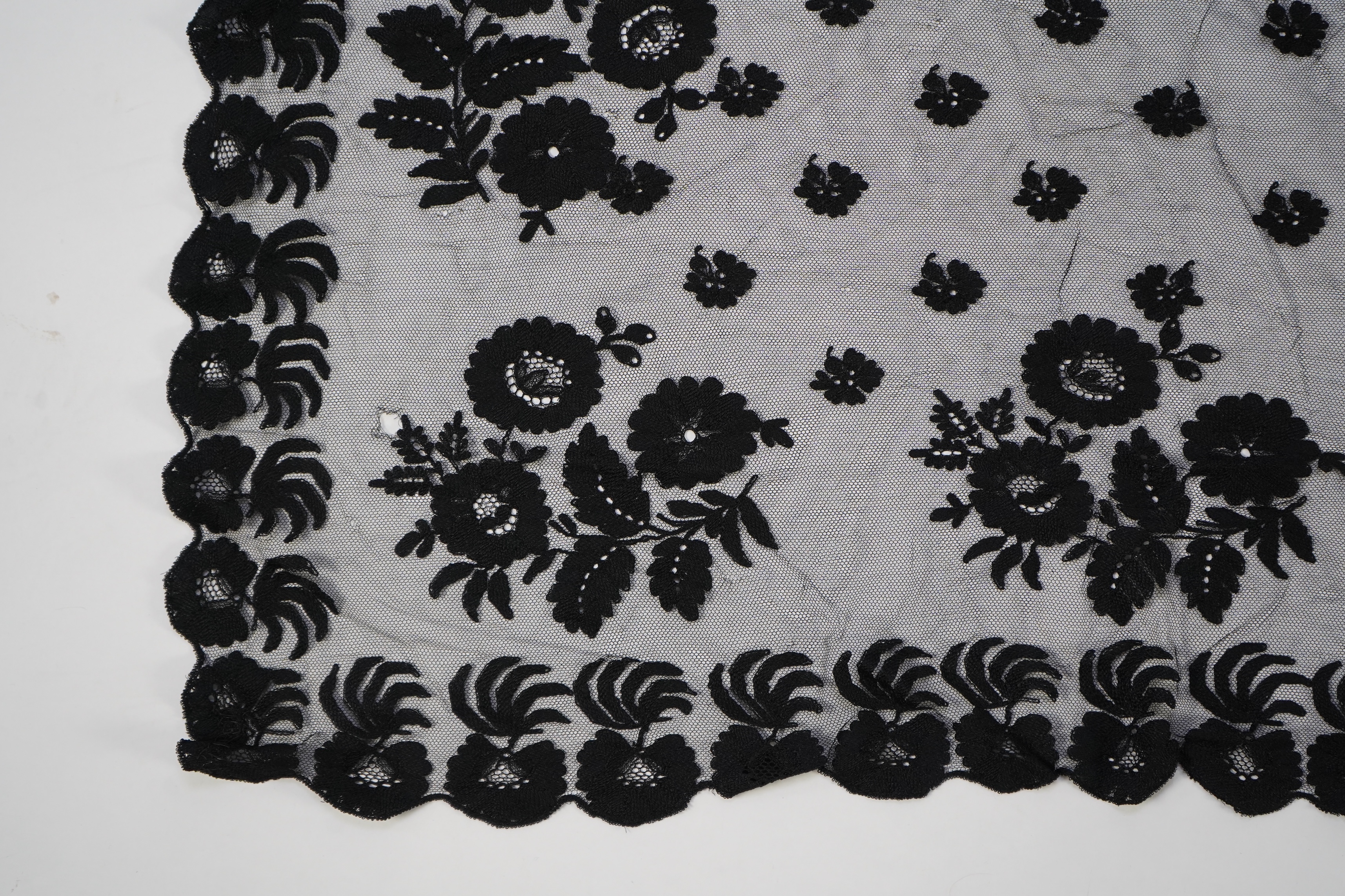 A collection of mixed machine lace: a black lace stole, two black veils, a sample of Japanese brocade, a length of metallic ribboning and various items of cream lace, ribboning 230cm long. Condition - variable poor to fa